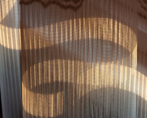 A bright home office in Chile with soft sunlight coming through sheer curtains