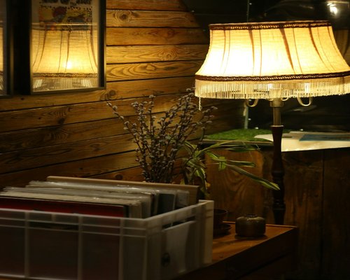 A cozy reading corner at night with a warm desk lamp highlighting a book